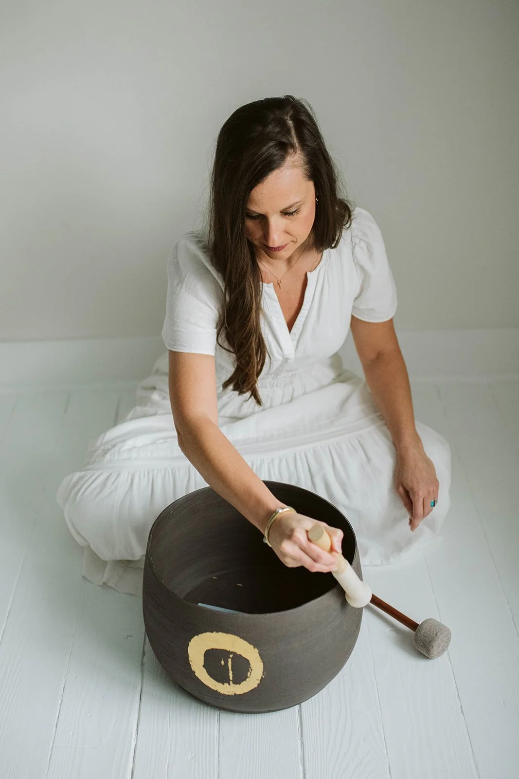 Libby playing a ceremonial sound bowl